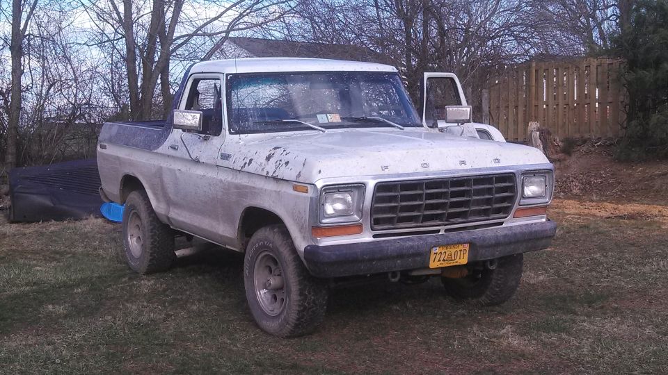 1977 Ford F-150 pickup truck with a blue bed liner, parked outdoors