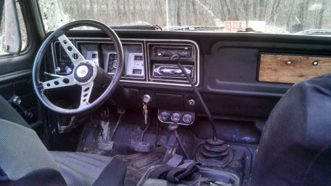 1979 Ford Bronco - The interior of a 1979 Ford Bronco features a distinctive steering wheel and dashboard layout.