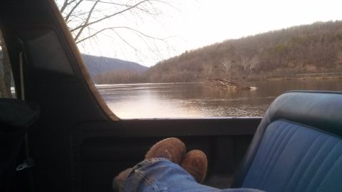 1979 Ford Bronco - View from inside a vehicle overlooking a river and hills during the day.