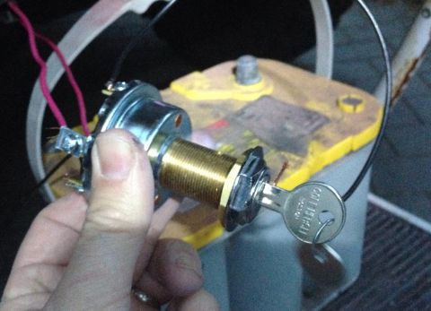 1979 Ford Bronco - A new ignition switch is being installed next to a car battery.