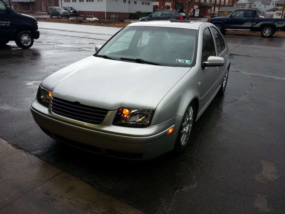 Silver 2002 Volkswagen Jetta parked on wet asphalt, front quarter view