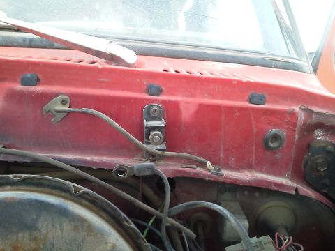 1979 Ford F-150 - Detail of wiring and components on the firewall of a vehicle, with a windshield wiper visible.