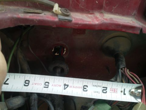 1979 Ford F-150 - Close-up of a red vehicle component with wiring and a tape measure.