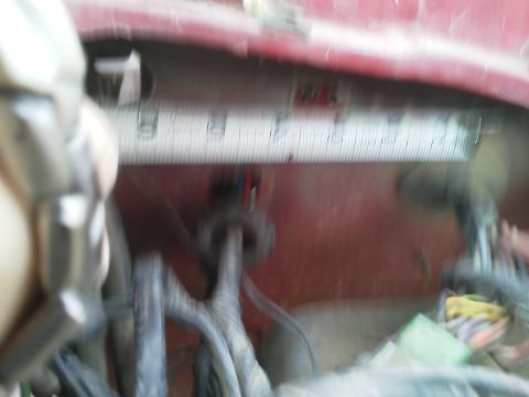 1979 Ford F-150 - Close-up of a wiring harness with a measuring tape, possibly for trailer wiring.