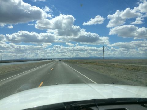 1996 Ford C-350 (Centurion Conversions) - Driving on a highway with a vast landscape and cloudy sky.