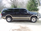 2003 Ford Excursion - This 2003 Ford Excursion SUV is shown in a side profile view, a two-tone black and tan paint scheme and a front brush guard.