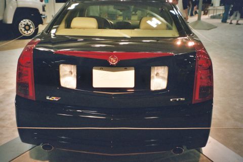1992 Mercury Grand Marquis - Rear view of a dark-colored Cadillac CTS, likely from the early 2000s.