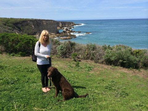 1996 Ford C-350 (Centurion Conversions) - A woman and her dog enjoy a scenic view of the ocean from a cliffside.