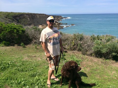 1996 Ford C-350 (Centurion Conversions) - A man and his dog enjoy a sunny day overlooking the ocean.