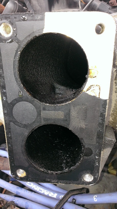 1988 Ford Bronco - Removed the throttle body to replace the TPS, and learned that the upper intake is full of crud. The build-up is terrible (about 1/16"…