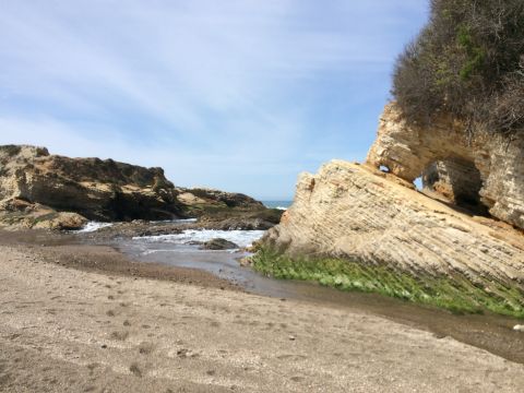 1996 Ford C-350 (Centurion Conversions) - A scenic view of coastal rock formations with waves crashing on the shore.