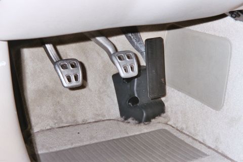 1992 Mercury Grand Marquis - Close-up view of the foot pedals inside a car's cabin.