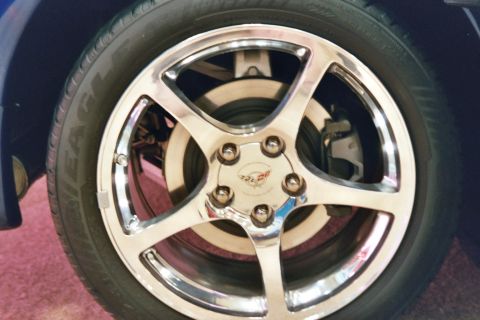 1992 Mercury Grand Marquis - Close-up of a chrome wheel with a Corvette emblem, indicating it is not a 1992 Mercury Grand Marquis.