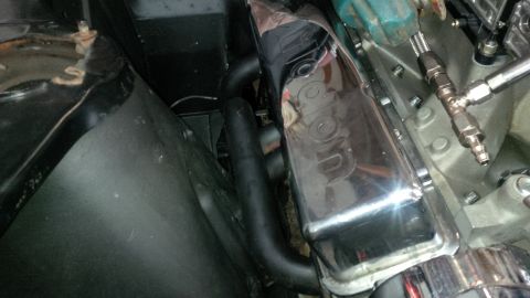 1963 Chevrolet Nova - Close-up of a chrome valve cover with 'Corvette' script, part of an engine assembly.