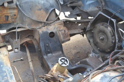 1981 Ford F-250 - Close-up view of a vehicle's engine bay and transmission assembly, showing disassembled parts.