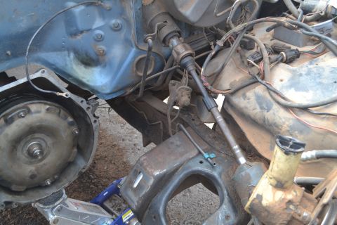 1981 Ford F-250 - The engine bay of a 1981 Ford F-250 shows the steering column and wiring harness with the transmission disconnected.