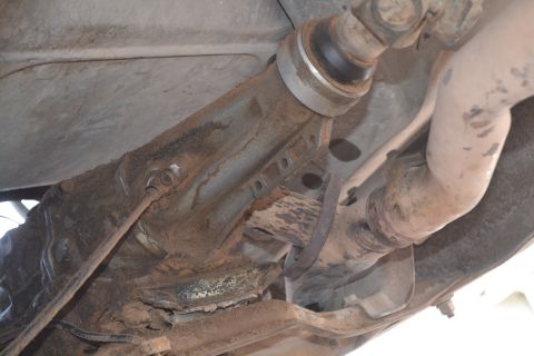 1981 Ford F-250 - Close-up view of the undercarriage of a vehicle, revealing the driveshaft and exhaust system.