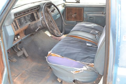 1981 Ford F-250 - Interior view of a 1981 Ford F-250, worn seats and a dashboard.