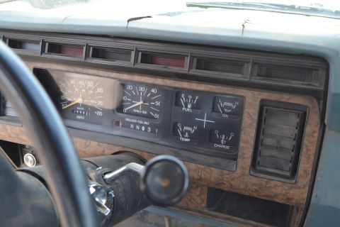 1981 Ford F-250 - The interior of a 1981 Ford F-250 displays its dashboard gauges and woodgrain trim.