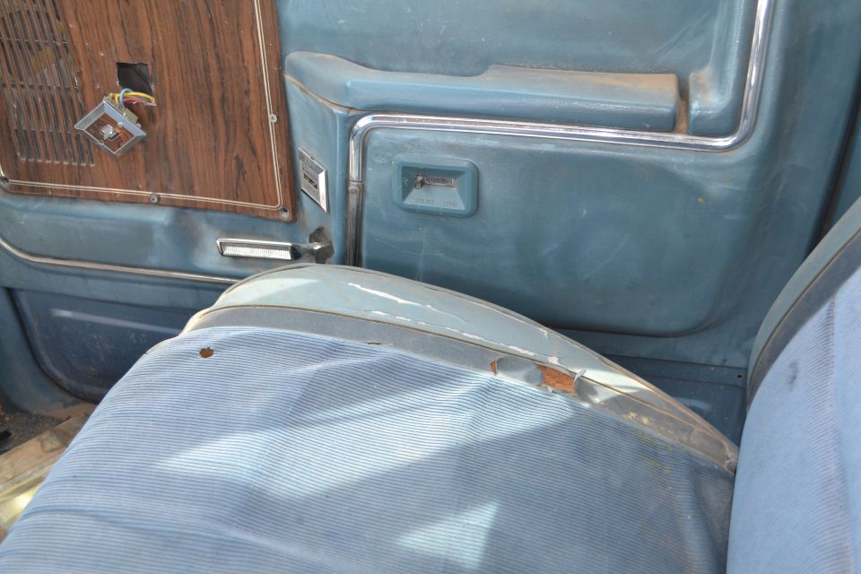 Blue interior door panel with wood trim and seat. Registry claims 1981 Ford F-250