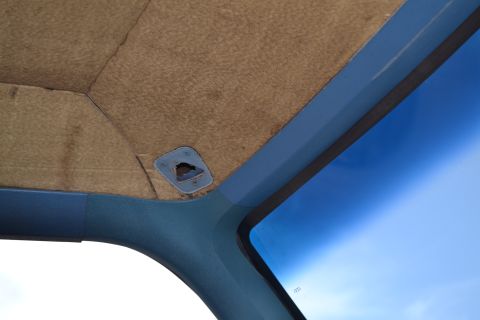 1981 Ford F-250 - Interior view of the ceiling and windshield corner of a 1981 Ford F-250.