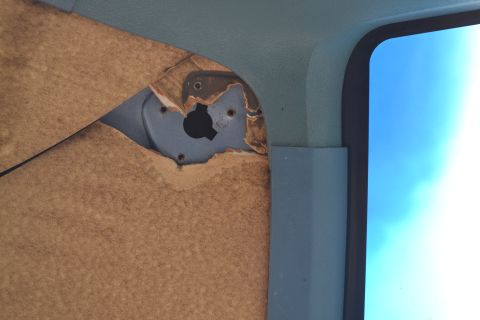 1981 Ford F-250 - Interior view of a vehicle's door panel showing damage and exposed metal structure.