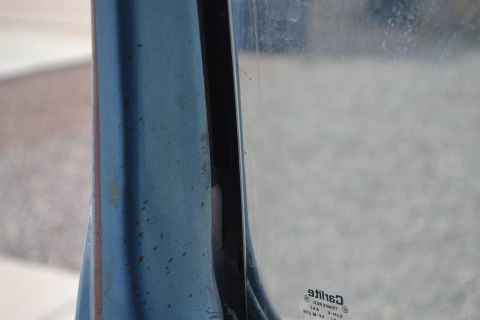 1981 Ford F-250 - Close-up of a vehicle's door frame and window, with a watermark visible on the glass.