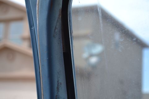 1981 Ford F-250 - Detail of the interior door frame and window, showing the SuperMotors logo at the bottom.