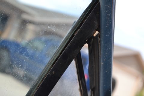 1981 Ford F-250 - Interior view of a vehicle's windshield frame and glass, with visible dust and wear.