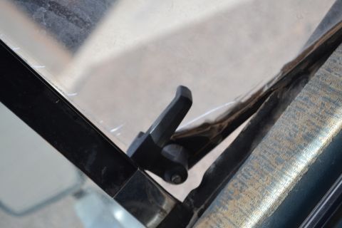 1981 Ford F-250 - A detail shot focuses on the window latch mechanism inside a vehicle.