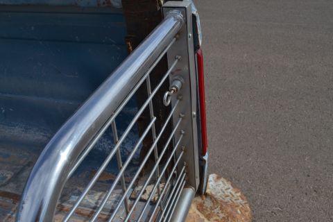 1981 Ford F-250 - Close-up of a truck's rear corner, showing a chrome rail and taillight assembly.