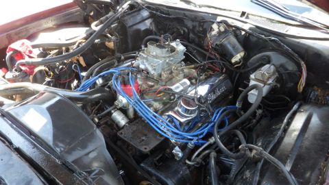 1972 Ford Ranchero - Engine bay details showing a V8 engine with a carburetor and blue spark plug wires.
