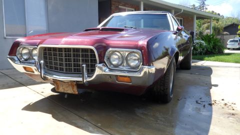 1972 Ford Ranchero - This 1972 Ford Ranchero features a distinctive grille and dual headlights, captured in a front three-quarter perspective.