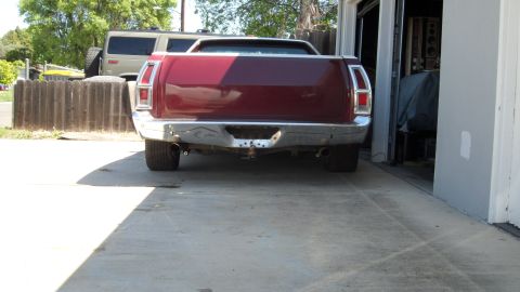 1972 Ford Ranchero - Rear view of a maroon 1972 Ford Ranchero parked in a driveway next to a garage.