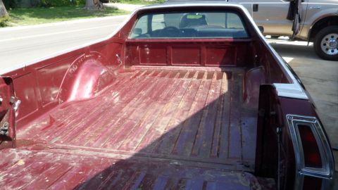 1972 Ford Ranchero - The rear bed of a 1972 Ford Ranchero pickup truck, showing its distinctive styling and a second truck parked behind it.