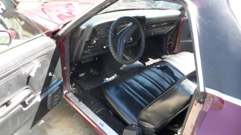 1972 Ford Ranchero - The interior of a 1972 Ford Ranchero shows black vinyl seats and a dashboard with a steering wheel.