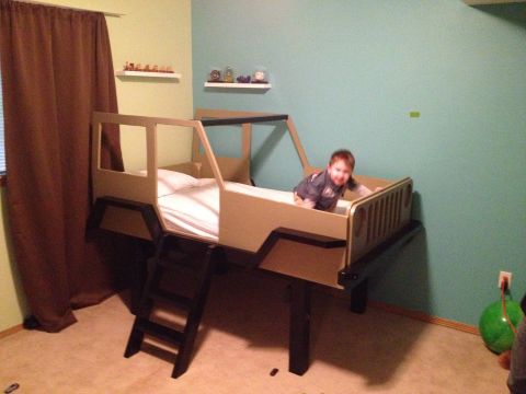 2005 Jeep Wrangler - A child plays in a bed designed to look like a Jeep, complete with a grille and roll cage.