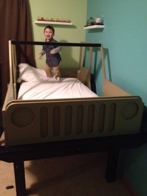 2005 Jeep Wrangler - A child plays in a bed designed to resemble the front of a Jeep.