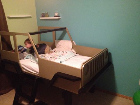 2005 Jeep Wrangler - This bed is shaped like a Jeep Wrangler and has a child in it.
