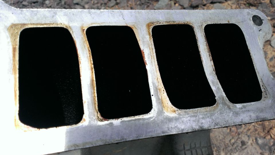 Upper intake manifold full of carbon build-up and grease.