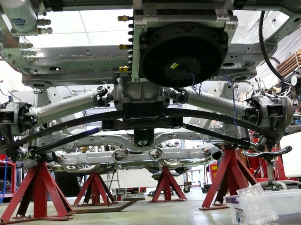 1976 Chevrolet Corvette underbody on jack stands, showing suspension and drivetrain components