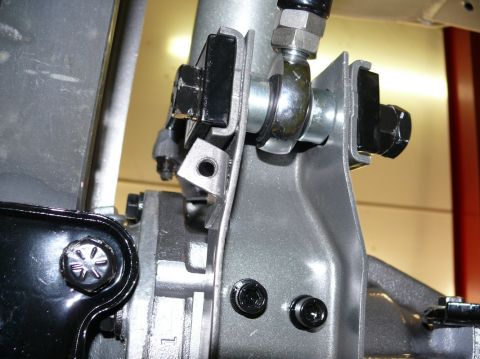 Close-up of suspension linkage with bolts and metal brackets