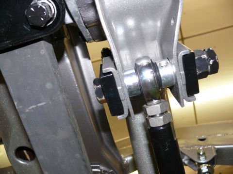 Close-up of suspension linkage with SuperMotors logo visible