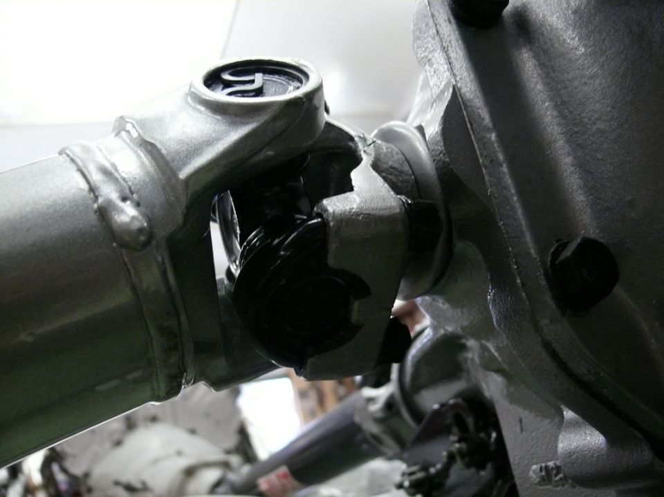 Driveshaft universal joint with silver metal casing and black components, close-up view