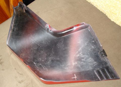 2008 Ford Crown Victoria - This is a close-up of a car part, likely a fender trim piece, with some visible markings and attachment points.