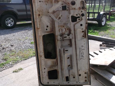 1971 Ford Ranchero - Rusty car door interior with handwritten '63 GAL' marking.