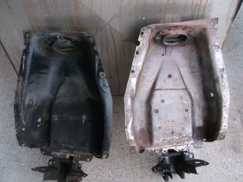 1971 Ford Ranchero - Two old car fuel tanks are shown side-by-side, one painted black and the other showing rust.