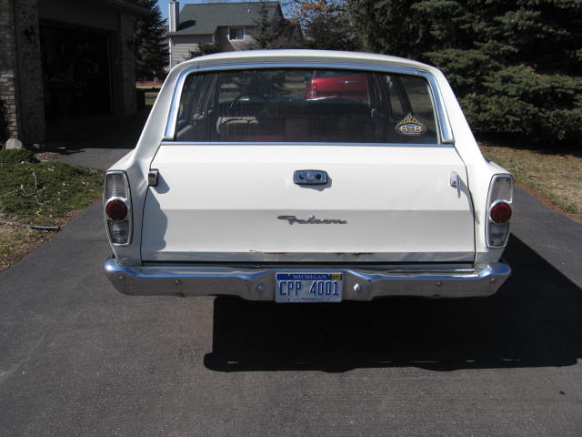 Rear view of a white 1966 Ford Falcon station wagon with a Michigan license plate