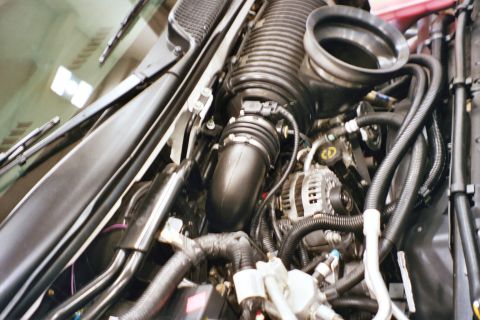 1992 Mercury Grand Marquis - Close-up view of a vehicle's engine bay, highlighting the air intake system and alternator.