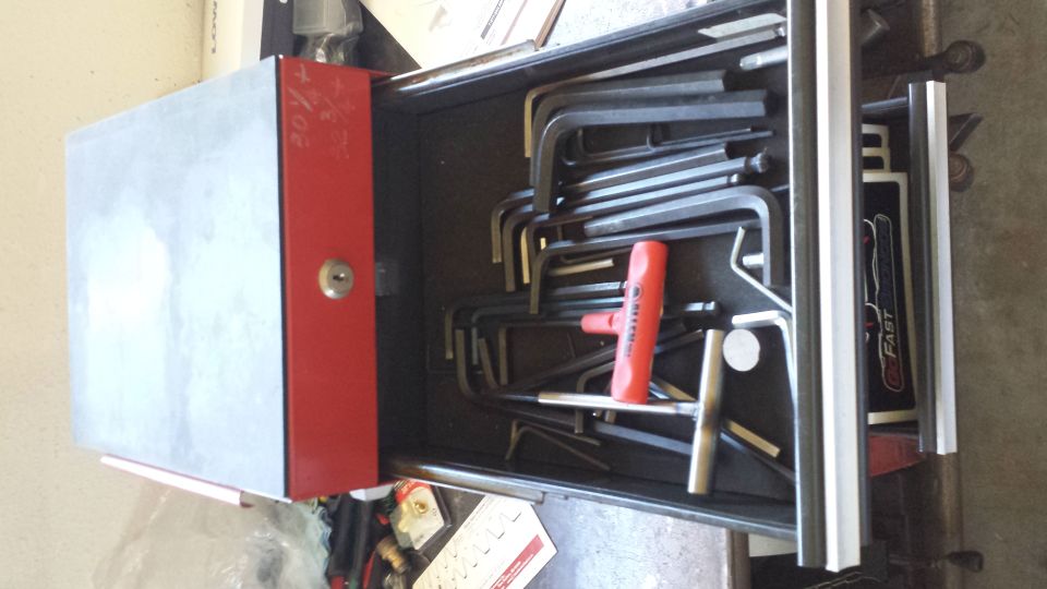 Tool drawer filled with hex keys and a red T-handle driver